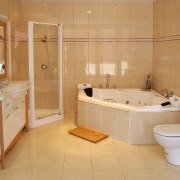 Bathroom with natural coloured wall and floor tiles, bathroom, bathtub, floor, flooring, property, room, tile, orange