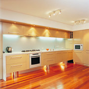 Kitchen with light veneer cabinetry, stone countertop, stainless cabinetry, ceiling, countertop, floor, flooring, hardwood, home, interior design, kitchen, laminate flooring, lighting, real estate, room, wall, wood, wood flooring, orange