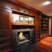 View of the fireplace in this living room cabinetry, fireplace, flooring, hardwood, hearth, home, interior design, living room, wood, red