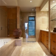 A view of the bathroom with light toned bathroom, cabinetry, floor, flooring, interior design, room, tile, brown, orange