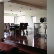 A view of the dining area with the ceiling, chair, dining room, floor, flooring, furniture, hardwood, home, interior design, laminate flooring, living room, room, table, window, wood, wood flooring, gray, black