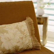 A view of a chair with ratten look bed sheet, cushion, duvet cover, furniture, linens, pillow, textile, throw pillow, yellow, brown, white