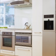 Kitchen with white cabinetry, and stainless steel finish cabinetry, countertop, cuisine classique, home appliance, kitchen, kitchen appliance, kitchen stove, major appliance, product, refrigerator, room, small appliance, white