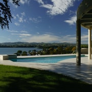 Overlooking the views from this Mediterranean-style house architecture, cloud, estate, home, house, property, real estate, resort, sea, sky, swimming pool, tree, villa, water, black