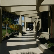 A curved path beneath the pergola which leads architecture, daylighting, floor, house, interior design, structure, table, window, black