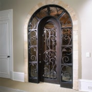 View of the entrance to the wine cellar arch, door, iron, window, white, gray, black