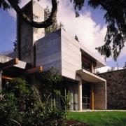 View of the exterior of this rusticated modern architecture, building, cottage, elevation, estate, facade, home, house, property, real estate, residential area, sky, villa, black