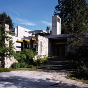 View of this modern house showing entrance way architecture, building, cottage, estate, facade, home, house, mansion, neighbourhood, plant, property, real estate, residential area, sky, tree, black