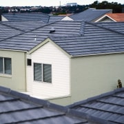 White house with grey coloured concrete roof tiles, daylighting, facade, home, house, outdoor structure, real estate, residential area, roof, siding, window, blue