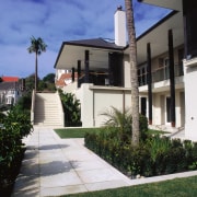 Large cream coloured stone tiles lead to front apartment, building, condominium, estate, facade, home, house, neighbourhood, property, real estate, residential area, villa, black