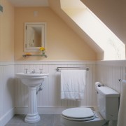 View of the bathroom installed with a skylight architecture, bathroom, bathroom accessory, bathroom cabinet, bathroom sink, bidet, daylighting, floor, home, house, interior design, plumbing fixture, product design, real estate, room, sink, tap, tile, toilet, toilet seat, wall, gray, brown