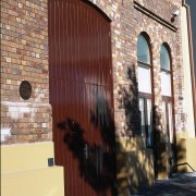 Brick heritage building with cream coloured base, and alley, arch, architecture, brick, brickwork, building, door, facade, wall, window