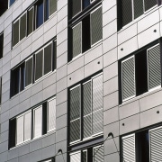 Preweathered zinc cladding panels were used on this apartment, architecture, building, commercial building, condominium, corporate headquarters, daytime, elevation, facade, house, line, metropolis, metropolitan area, residential area, siding, structure, tower block, urban area, window, white, black