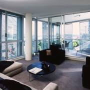 Apartment interior with grey carpet, cream sofas, black apartment, architecture, condominium, daylighting, house, interior design, living room, loft, penthouse apartment, property, real estate, shade, window, window blind, window covering, window treatment, gray, black