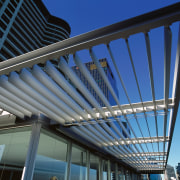 Automatic aluminium elliptical louvres provide this apartment with architecture, building, corporate headquarters, daylighting, daytime, facade, line, roof, sky, structure, black, blue