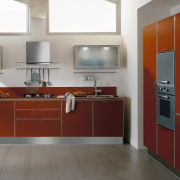 View of this modern kitchen with red cabinetry. cabinetry, countertop, cuisine classique, floor, home appliance, interior design, kitchen, product design, room, gray, red, white