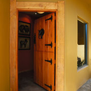 View of the front entrance of this home door, home, house, wall, window, wood, brown, orange