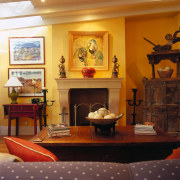 View of this living area - View of furniture, home, interior design, living room, room, table, wall, brown, orange, red