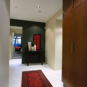 Apartment entranceway with stone floor and red rug, ceiling, floor, flooring, interior design, lobby, room, brown, gray