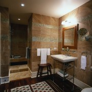 Glass mosaic borders on the marble walls of bathroom, ceiling, floor, flooring, home, interior design, real estate, room, tile, wall, brown