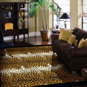 View of this animal print floor rug by carpet, floor, flooring, hardwood, home, interior design, living room, wood flooring, black, brown