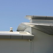 Top section of apartment building showing cladding panels architecture, building, daylighting, facade, house, roof, sky, technology, teal, gray