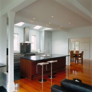 Kitchen with barstools at large kitchen island with cabinetry, ceiling, countertop, floor, flooring, hardwood, interior design, kitchen, real estate, room, wood flooring, gray