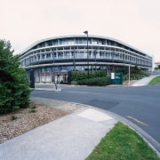 Exterior of new health complex building with extensive architecture, building, corporate headquarters, fixed link, headquarters, infrastructure, metropolitan area, sky, structure, white