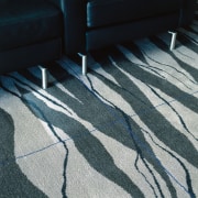 Patterned carpet with grid pattern, and black chairs. angle, blue, carpet, floor, flooring, line, road surface, shadow, wood, black