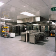 Commercial kitchen with stainless steel equipment including ovens gray