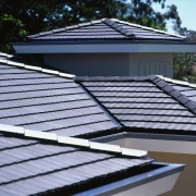 View of grey concrete tiles on roof, with daylighting, line, roof, solar panel, solar power, black, teal