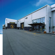 Exterior view of building sales and service area architecture, asphalt, building, car, commercial building, facade, property, sky, structure, gray