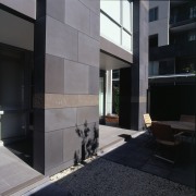 Courtyard of apartment building with basalt veneer cladding, architecture, building, condominium, facade, floor, glass, house, interior design, wall, window, black, gray