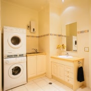 Laundry and bathroom area with front loading washing bathroom, clothes dryer, home appliance, laundry room, major appliance, room, washing machine, orange