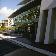 Exterior view of section of building showing sloping architecture, building, corporate headquarters, facade, metropolitan area, reflection, sky, structure, black