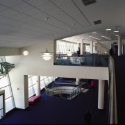 View looking down into lobby, showing structural steel ceiling, daylighting, interior design, gray, black