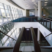 Interior of building looking down escalator to lower architecture, building, daylighting, glass, handrail, leisure centre, metropolitan area, stairs, structure, gray, black