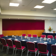 Meeting and function room in complex with long auditorium, conference hall, function hall, interior design, table, gray