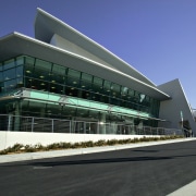 Exterior corner view of convention building showing walls architecture, building, commercial building, convention center, corporate headquarters, facade, headquarters, mixed use, sky, structure, black, blue