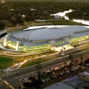 View looking down at large multi-functional complex with aerial photography, arena, bird's eye view, city, sport venue, stadium, structure, urban area, brown