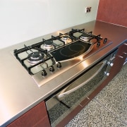 Gas cooktop set into stainless steel bench. - countertop, furniture, table, white