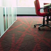 Textured carpet with red pattern, patterned glass partition, carpet, chair, floor, flooring, hardwood, interior design, laminate flooring, red, table, tile, wall, wood, wood flooring, black, gray