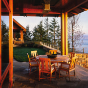 Exterior view of the patio area, stone pavers, cottage, evening, home, house, lighting, outdoor structure, real estate, restaurant, sky, table, black