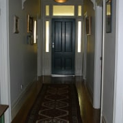 Hallway of villa with timber floor, long runner ceiling, door, estate, floor, flooring, hall, hardwood, home, house, interior design, laminate flooring, lighting, property, real estate, room, stairs, wall, window, wood, wood flooring, black, gray