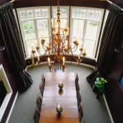 Formal dining room with double height ceiling, dark dining room, flooring, furniture, interior design, living room, room, table, black, white