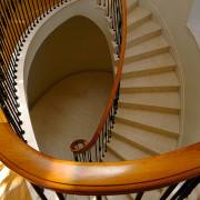 View looking down curved stairway with marble steps, architecture, baluster, daylighting, furniture, handrail, line, spiral, stairs, wood, brown