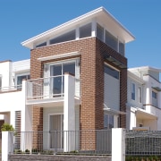 Exterior of multi-storey home with brick and white apartment, architecture, building, commercial building, condominium, elevation, estate, facade, home, house, mixed use, neighbourhood, property, real estate, residential area, villa, teal, gray