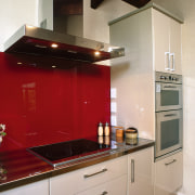 Kitchen with cream cabinetry, red splashback, stainless steel cabinetry, countertop, cuisine classique, home appliance, interior design, kitchen, kitchen appliance, kitchen stove, room, gray