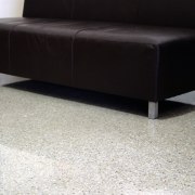 Black sofa on polished concrete floor, with flecked angle, coffee table, couch, floor, flooring, furniture, hardwood, laminate flooring, product design, table, wood, wood flooring, black, white, gray