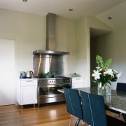 Kitchen with large stainless steel cooker, cooktop and cabinetry, ceiling, countertop, floor, flooring, home, interior design, kitchen, living room, real estate, room, gray, brown